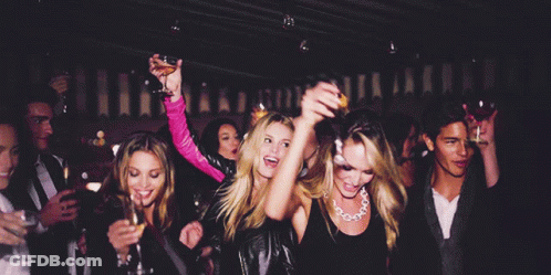 Group Dancing At Party Woman Holding Orange Juice GIF