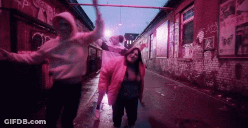 Group Dancing In Alleyway With Pink Lights GIF
