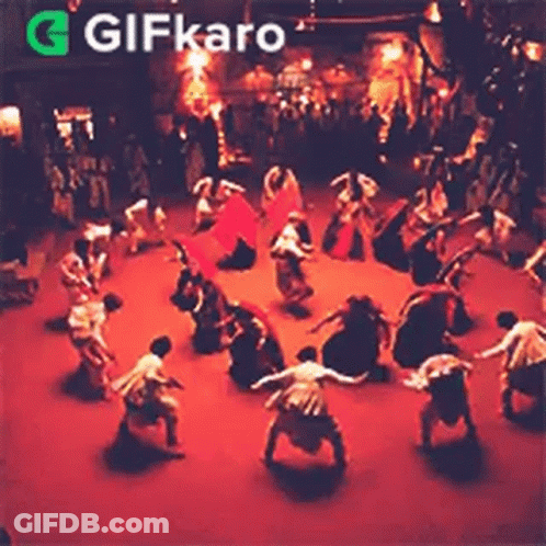 Group Dancing In Circle On Stage In Dark Room GIF