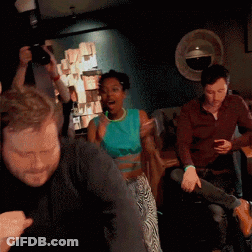 Group Dancing In Dark Room With Man Taking Picture GIF