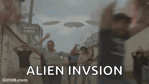 Group Dancing In Front Of Alien Invision Sign GIF