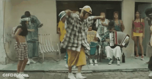 Group Dancing In Front Of Building With Accordion Player GIF