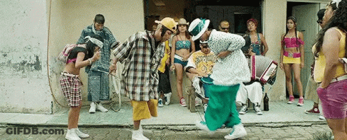 Group Dancing In Front Of Building With Accordion Player GIF