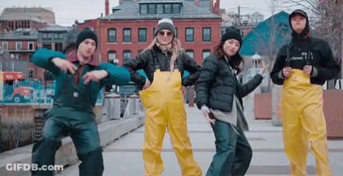 Group Dancing In Front Of Building With Sign GIF
