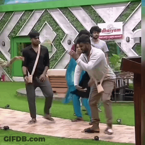 Group Dancing In Front Of Dharmam Sign GIF