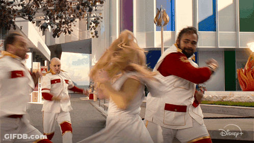 Group Dancing In Front Of Disney Plus Building GIF