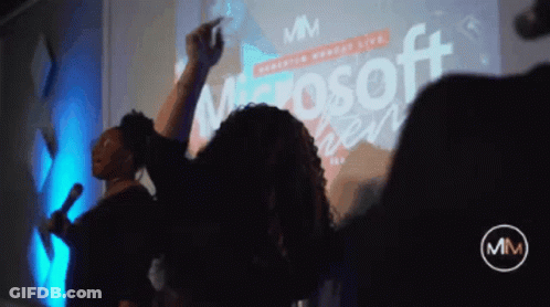 Group Dancing In Front Of Microsoft Screen GIF