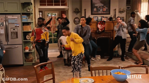 Group Dancing In Front Of Netflix Sign GIF