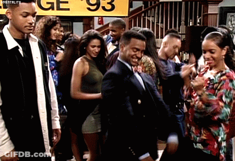 Group Dancing In Front Of Yellow Sign Saying Ge 93 GIF
