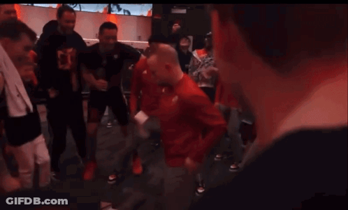 Group Dancing In Room With Red Allianz Sign GIF