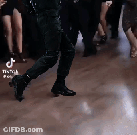 Group Dancing On Dance Floor With TikTok Logo GIF