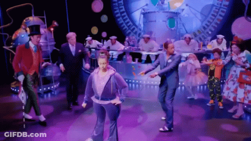 Group Dancing On Stage, One In Purple Hoodie GIF