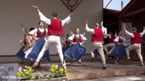 Group Dancing On Stage With A Sign GIF