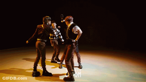Group Dancing On Stage With Letter M GIF