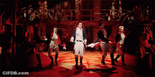 Group Dancing On Stage With Man Holding Sword GIF