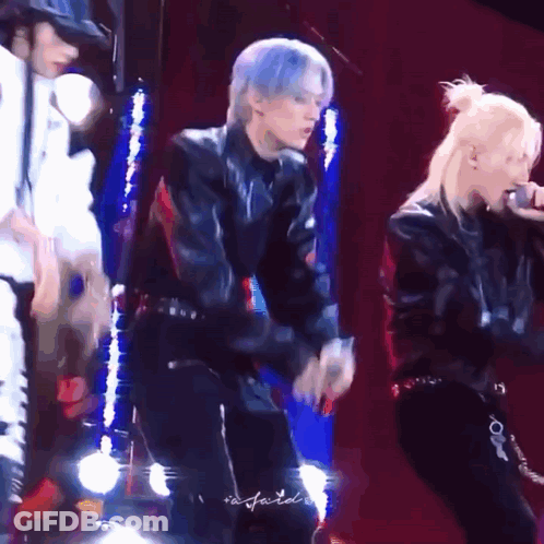 Group Dancing On Stage With One Singing Into Microphone GIF