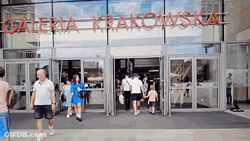 Group Entering Galeria Krakowska Store GIF