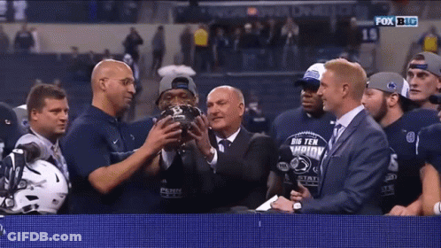 Group Holding Big Ten Championship Trophy GIF