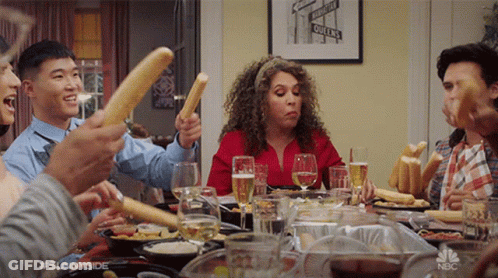 Group Holding Bread Sticks In Air GIF