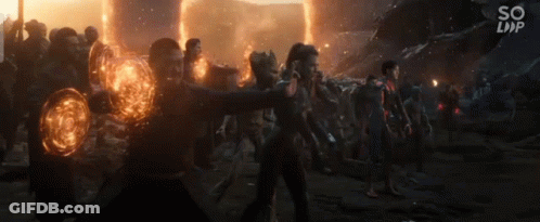 Group Holding Glowing Orbs In Dark Room GIF