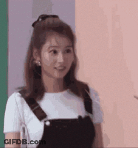 Group Holding Paper In Front Of Brick Building GIF