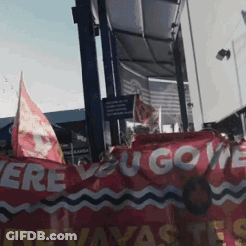Group Holding Red Banner Saying Ere You Gove GIF