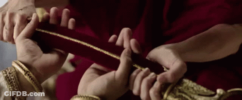Group Holding Red Cloth With Gold Trim GIF