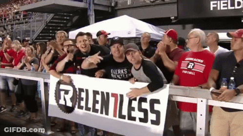 Group Holding Sign Saying Relentless GIF
