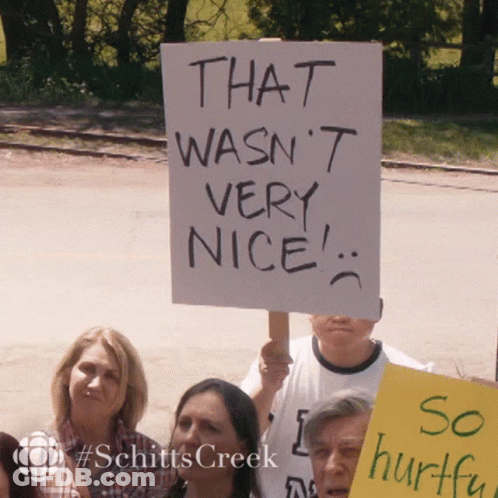 Group Holding Sign That Wasn't Nice GIF