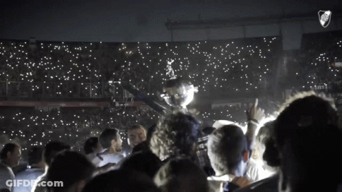 Group Holding Trophy In Stadium With River Plate Logo GIF