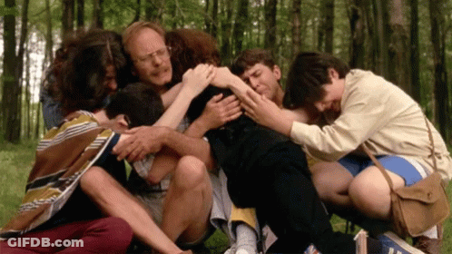 Group Huddled In Circle In Woods GIF