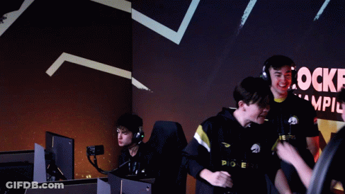 Group Hugging In Front Of Rocke Champions Sign GIF