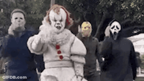 Group In Clown And Scream Masks Standing Together GIF