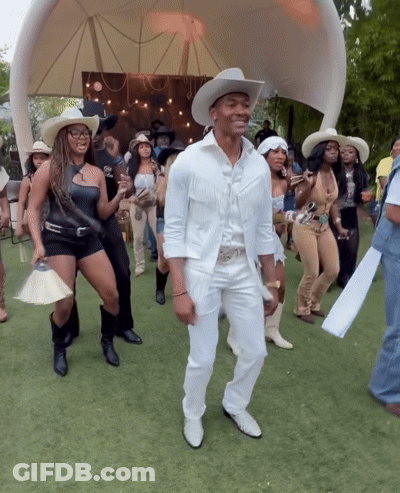 Group In Cowboy Hats Dancing In Field GIF