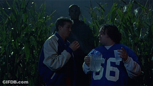 Group In Field With Man In Mask GIF