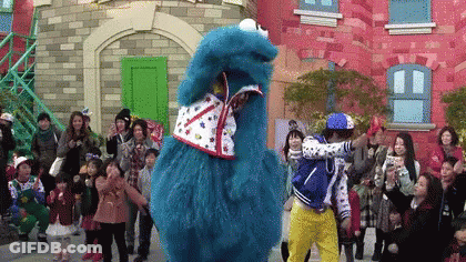 Group In Front Of Cookie Monster Costume GIF