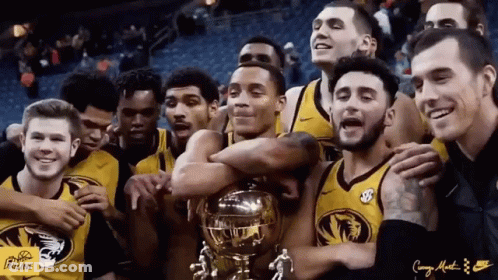 Group In Front Of Drum Set With Big Ten Conference Sign GIF