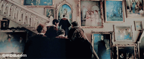 Group In Front Of Framed Pictures GIF