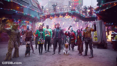 Group In Front Of Guardians Of The Galaxy Sign GIF