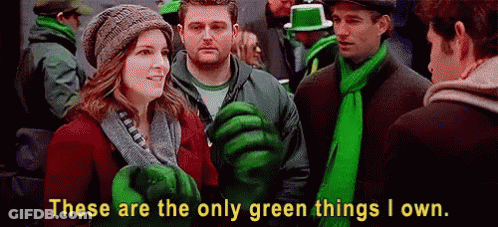 Group In Green Clothes And Scarves In Crowd GIF