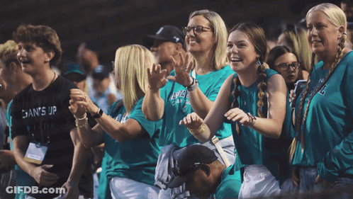 Group In Green Shirts Saying Gains GIF