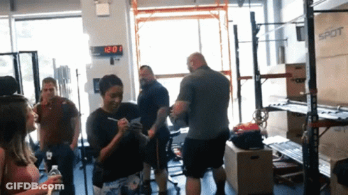 Group In Gym With 12:20 Clock GIF