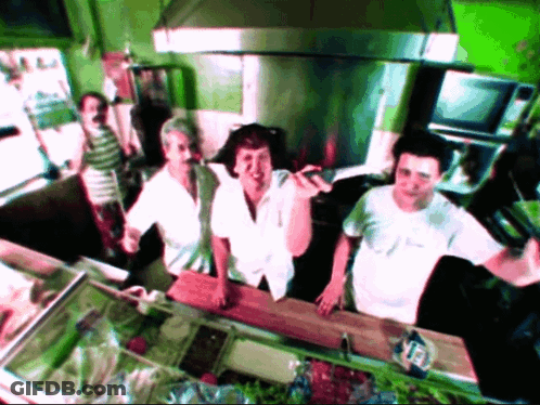 Group In Kitchen One Wearing White Shirt Saying A GIF