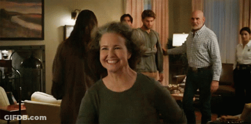 Group In Living Room With Smiling Woman GIF