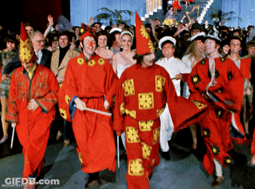 Group In Red And Yellow Costumes Dancing GIF