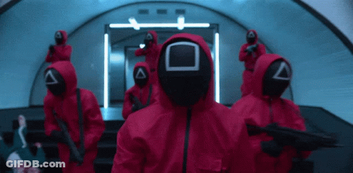 Group In Red Jumpsuits And Masks GIF
