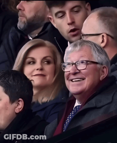 Group In Stadium With Man Wearing Glasses GIF