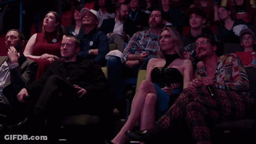 Group In Stadium With Man Wearing I Love You Sticker GIF