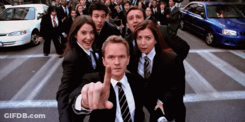 Group In Suits And Ties Standing Before Crowd GIF