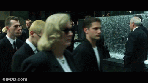 Group In Suits Walking By Waterfall GIF